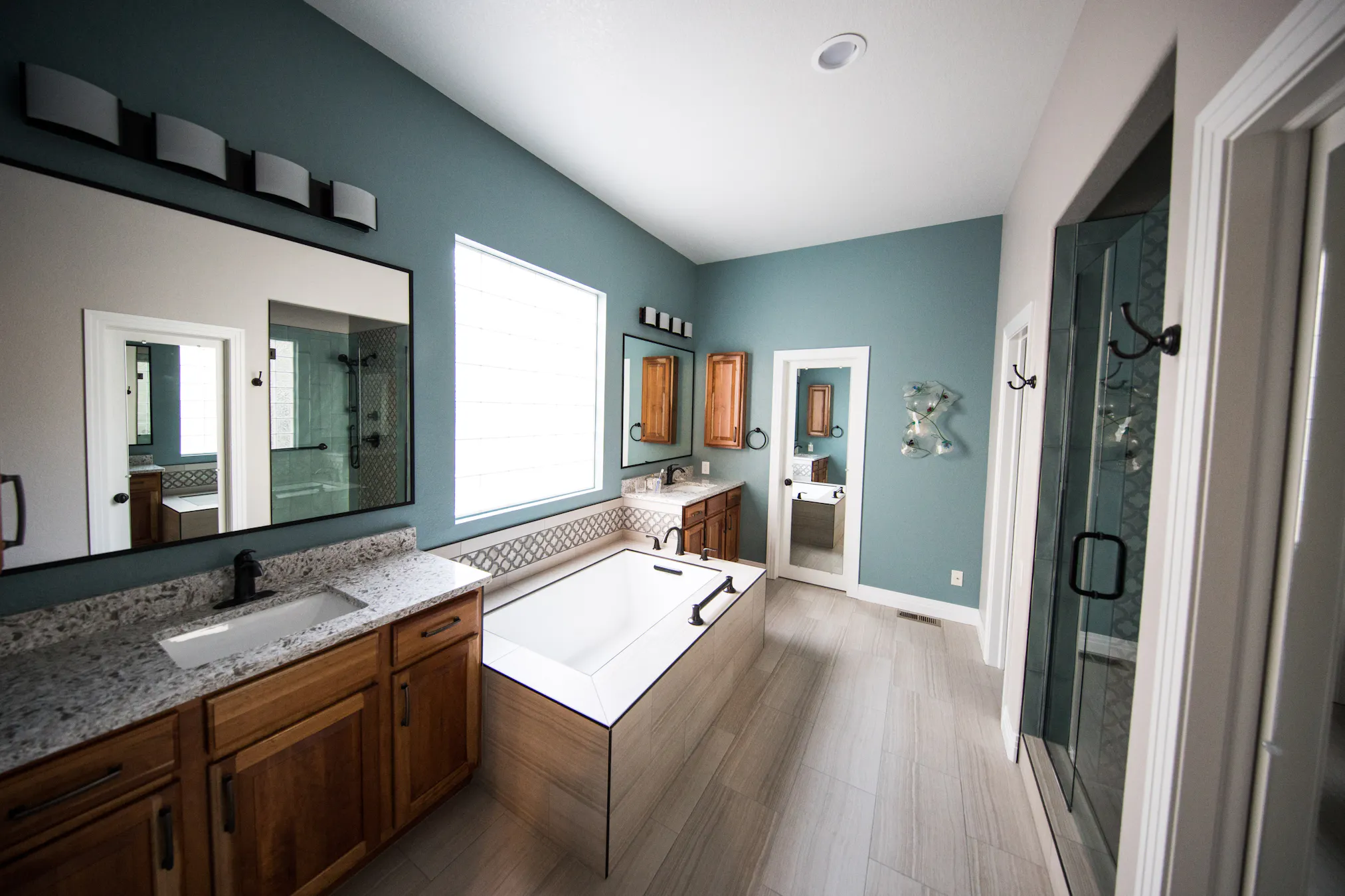 Bathroom with a double vanity and bathtub, shown as design inspiration